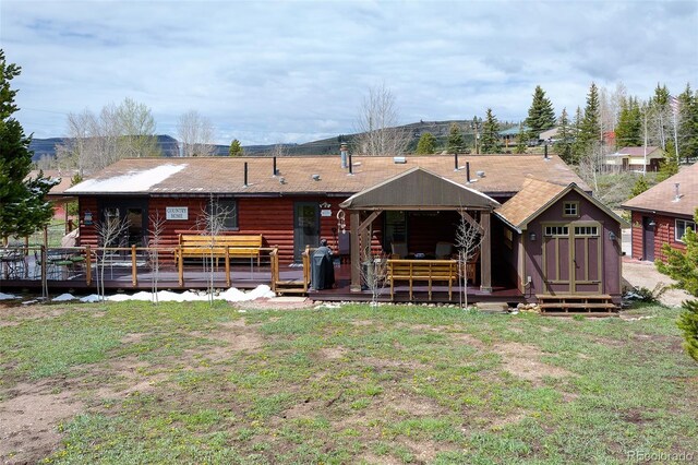 110 County Road 652, Grand Lake, CO 80447 - rear view of property featuring a deck, log siding, and a lawn