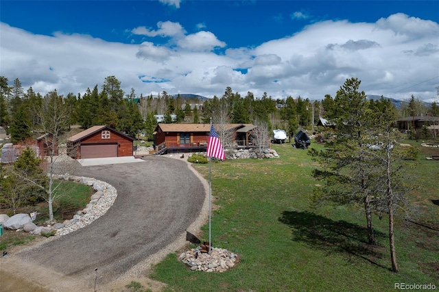 110 County Road 652, Grand Lake, CO 80447 - view of front of property with a mountain view, a garage, a front lawn, an outbuilding, and driveway