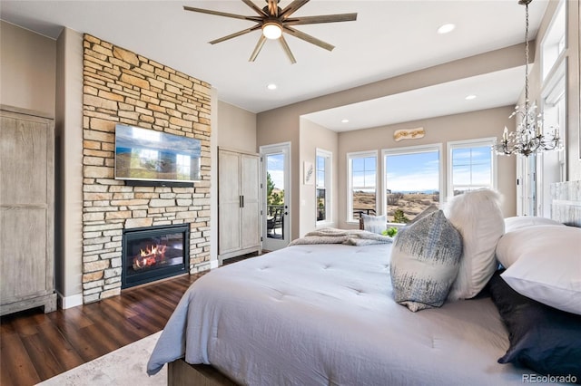 9563 Red Primrose St, Franktown, CO 80116 - bedroom featuring wood finished floors, access to exterior, recessed lighting, a fireplace, and a chandelier