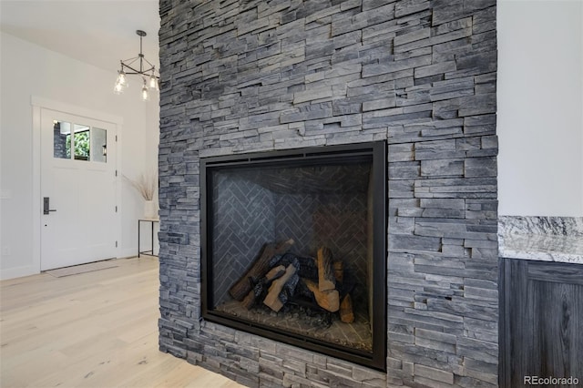 16510 Early Light Dr, Colorado Springs, CO 80908 - details featuring a stone fireplace and wood finished floors