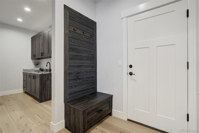 16510 Early Light Dr, Colorado Springs, CO 80908 - mudroom featuring recessed lighting, baseboards, a sink, and light wood finished floors