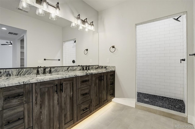 16510 Early Light Dr, Colorado Springs, CO 80908 - full bath featuring a sink, double vanity, tiled shower, and visible vents