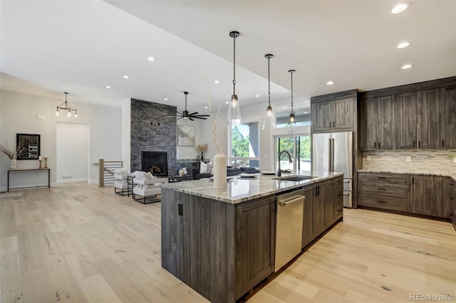 16510 Early Light Dr, Colorado Springs, CO 80908 - kitchen featuring open floor plan, recessed lighting, a sink, light wood finished floors, and stainless steel appliances