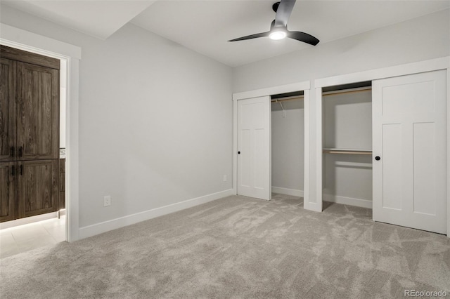 16510 Early Light Dr, Colorado Springs, CO 80908 - unfurnished bedroom with multiple closets, baseboards, light carpet, and ceiling fan