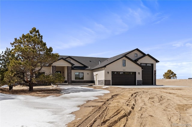 16510 Early Light Dr, Colorado Springs, CO 80908 - modern farmhouse featuring stucco siding, a garage, stone siding, and driveway