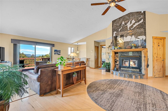10786 Marclif Rd, Conifer, CO 80433 - living area featuring lofted ceiling, ceiling fan, a fireplace, and light wood-style floors