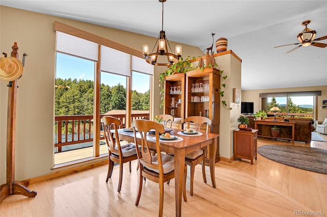 10786 Marclif Rd, Conifer, CO 80433 - dining room featuring light wood-style floors, ceiling fan, a chandelier, vaulted ceiling, and baseboards