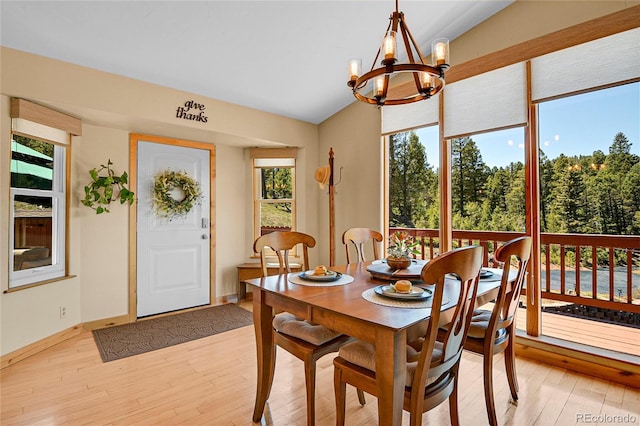 10786 Marclif Rd, Conifer, CO 80433 - dining area featuring lofted ceiling, a chandelier, light wood-style floors, and baseboards