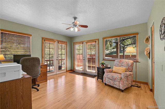 10786 Marclif Rd, Conifer, CO 80433 - office area featuring french doors, a ceiling fan, light wood-style flooring, plenty of natural light, and a textured ceiling
