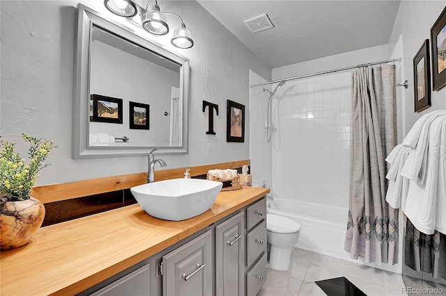 10786 Marclif Rd, Conifer, CO 80433 - full bathroom with a textured wall, tile patterned flooring, vanity, shower / tub combo, and toilet