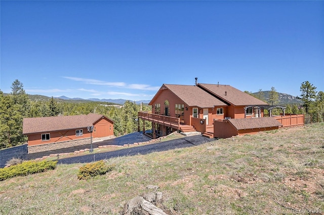 10786 Marclif Rd, Conifer, CO 80433 - back of house featuring a deck with mountain view and fence