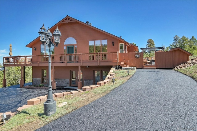 10786 Marclif Rd, Conifer, CO 80433 - view of front of house featuring a deck and stone siding