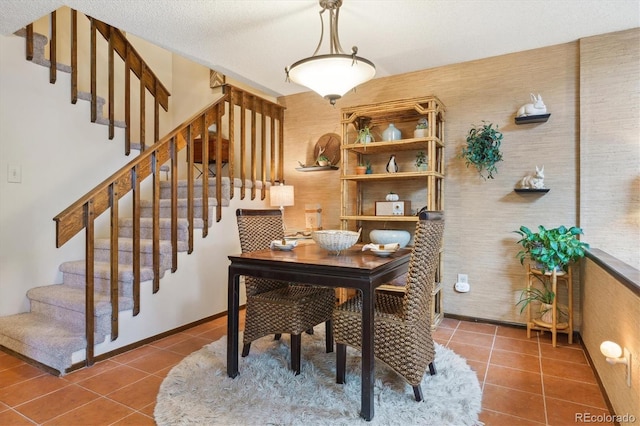 dining space featuring tile patterned flooring and stairway