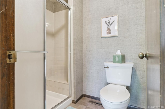 full bathroom with a shower stall and toilet