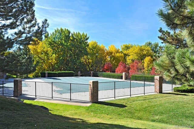 view of swimming pool featuring view of scattered trees