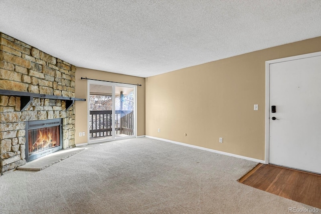 1876 S Pitkin Cir Unit B, Aurora, CO 80017 - unfurnished living room featuring carpet floors, a textured ceiling, and a fireplace