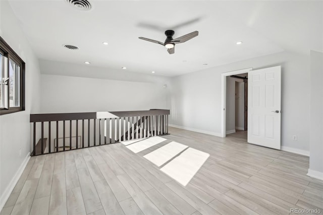 spare room with recessed lighting, visible vents, light wood-type flooring, and a ceiling fan