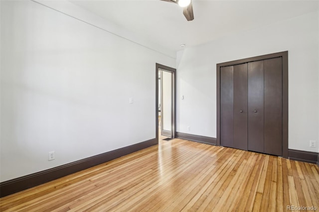 unfurnished bedroom with a closet, light wood-style floors, baseboards, and a ceiling fan