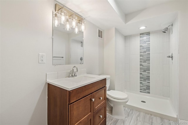 full bath featuring a shower stall, vanity, visible vents, and toilet