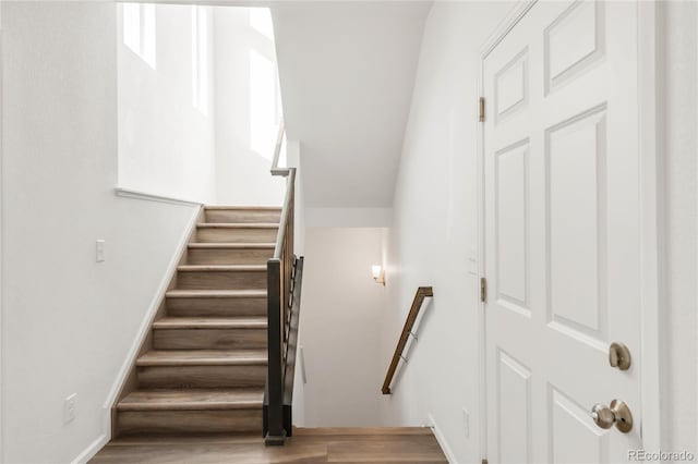 stairs with baseboards and wood finished floors