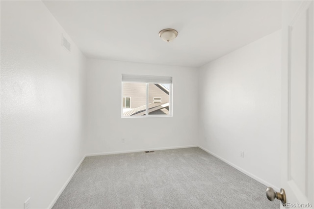 spare room featuring visible vents, baseboards, and carpet floors