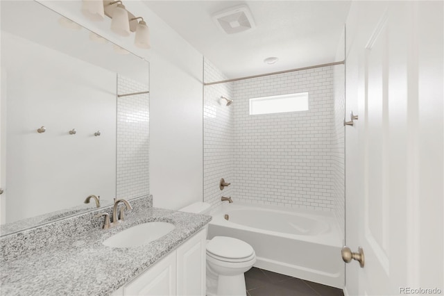 bathroom with tile patterned flooring, visible vents, tub / shower combination, toilet, and vanity