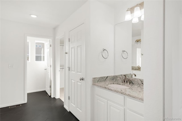 bathroom with tile patterned flooring, visible vents, vanity, and baseboards