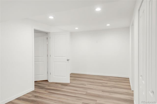 unfurnished room with recessed lighting, light wood-type flooring, and baseboards