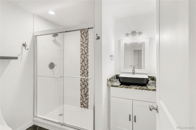 full bathroom featuring vanity, a shower stall, and recessed lighting