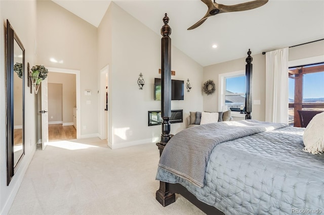 bedroom with multiple windows, access to outside, light colored carpet, and high vaulted ceiling