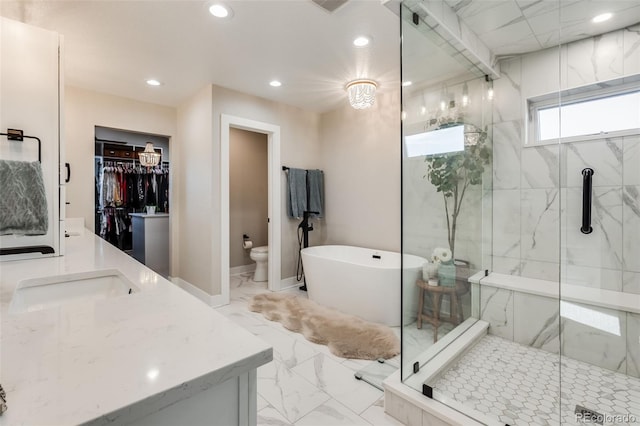 full bathroom with vanity, separate shower and tub, and toilet