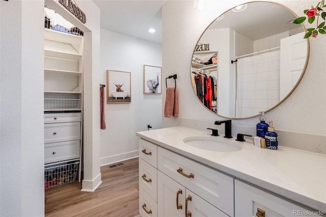 bathroom with vanity, hardwood / wood-style flooring, and a shower with curtain