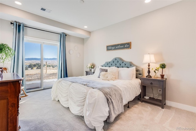 carpeted bedroom with a mountain view and access to outside