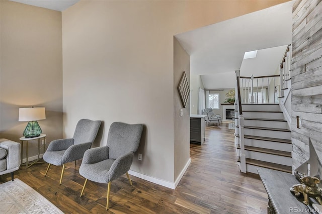 interior space featuring stairs, a skylight, dark wood finished floors, and baseboards