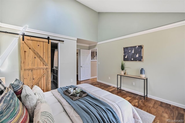 bedroom featuring a barn door, baseboards, high vaulted ceiling, and wood finished floors