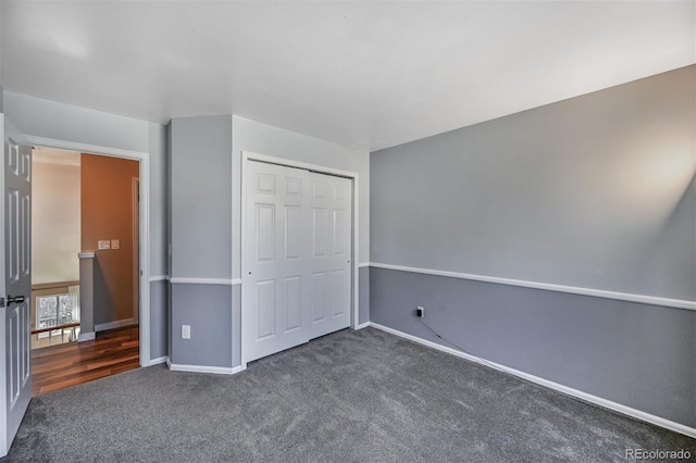 unfurnished bedroom featuring a closet, baseboards, and carpet floors