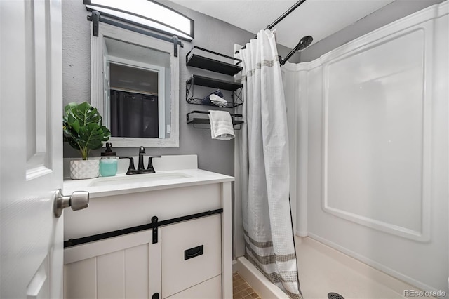 bathroom featuring a shower with curtain and vanity