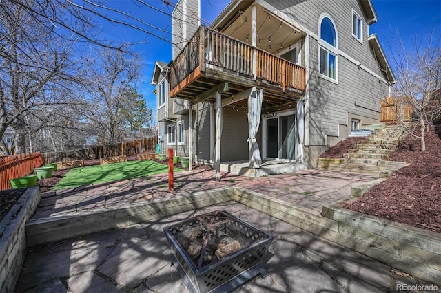 back of house with a patio area, a yard, a fire pit, and a fenced backyard