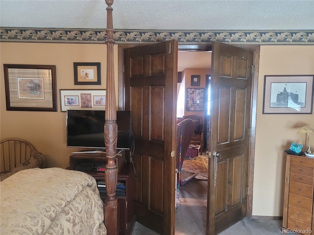 bedroom with carpet flooring and a textured ceiling