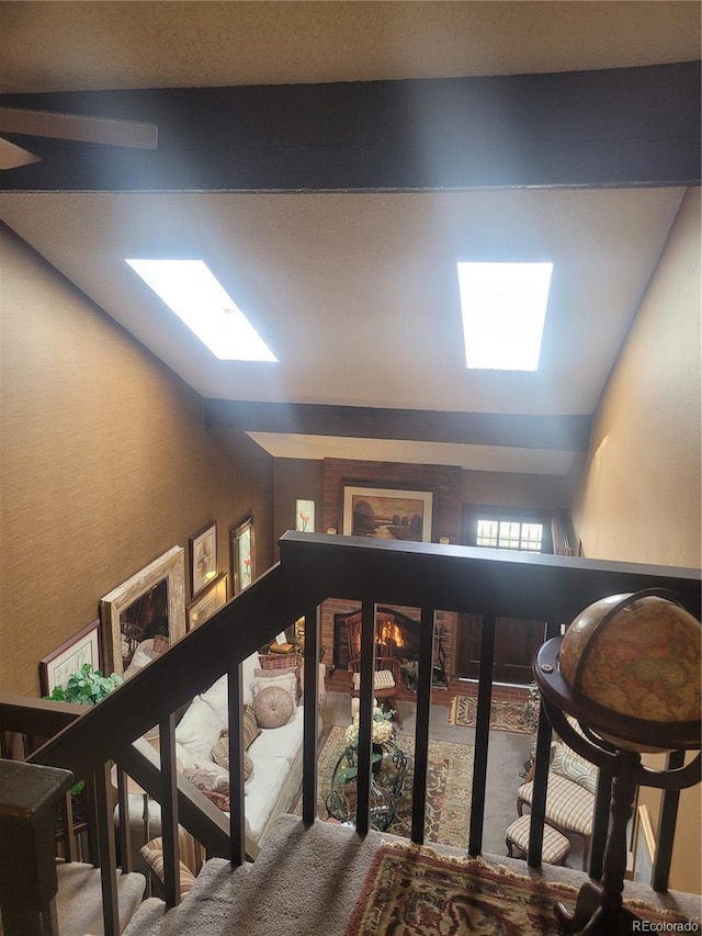 interior space featuring carpet and vaulted ceiling with skylight