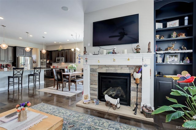 4767 S Odessa St, Centennial, CO 80015 - living room with dark wood-style floors, recessed lighting, and a stone fireplace
