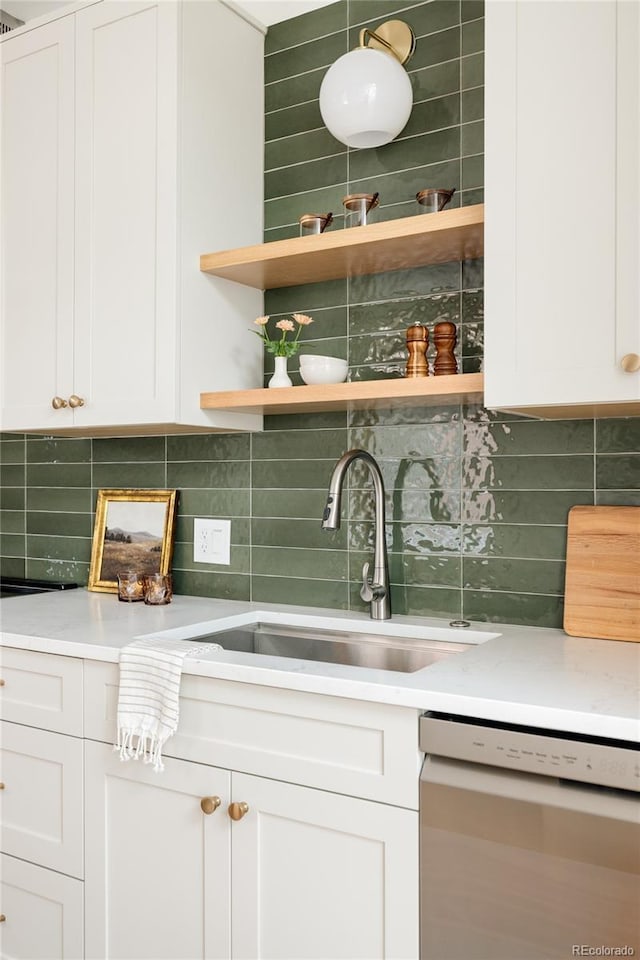 bar featuring dishwasher, backsplash, and a sink