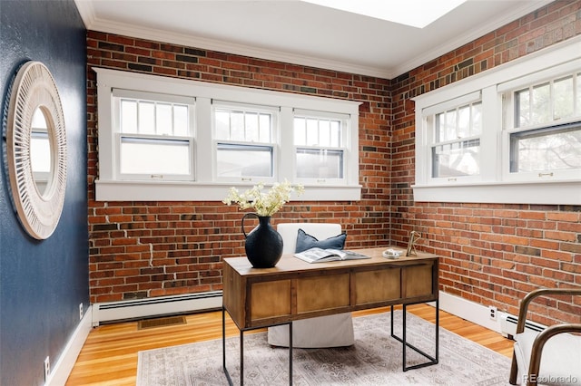 office space featuring light wood-type flooring, brick wall, ornamental molding, and a baseboard radiator