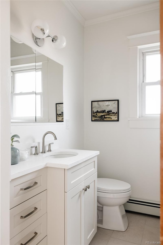 bathroom featuring tile patterned flooring, toilet, vanity, baseboard heating, and crown molding