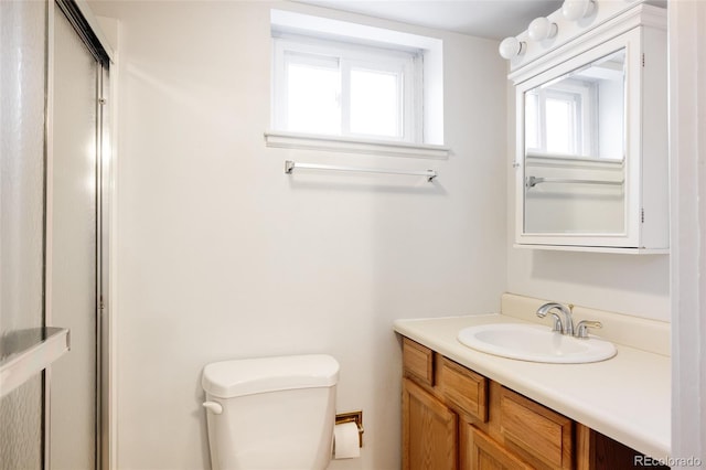 full bath featuring vanity, toilet, and an enclosed shower