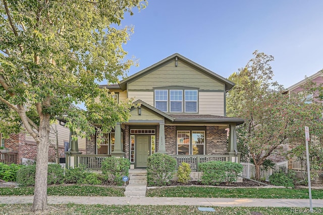 5892 W 94th Pl, Westminster, CO 80031 - view of front of property with covered porch, brick siding, and fence