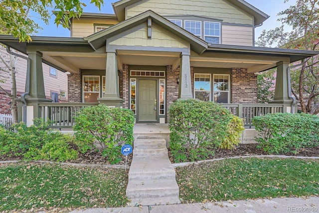 5892 W 94th Pl, Westminster, CO 80031 - view of front facade featuring covered porch and brick siding