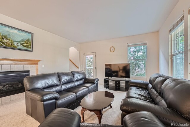 5892 W 94th Pl, Westminster, CO 80031 - carpeted living area featuring a tiled fireplace and stairway