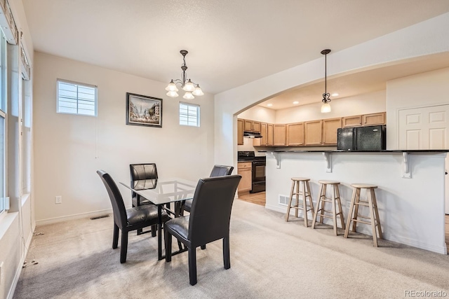 5892 W 94th Pl, Westminster, CO 80031 - dining space with healthy amount of natural light, light carpet, arched walkways, a chandelier, and recessed lighting