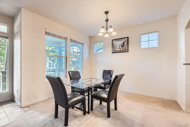 dining area with an inviting chandelier, light carpet, and plenty of natural light